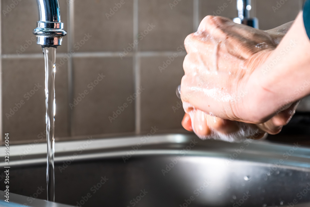 Wall mural proper washing of hands demonstrated at steel kitchen sink