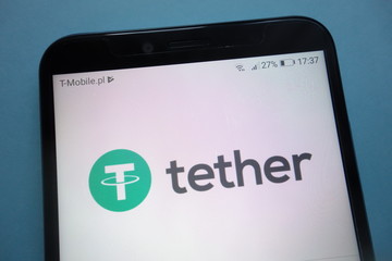 KONSKIE, POLAND - SEPTEMBER 29, 2018: Tether cryptocurrency logo on smartphone