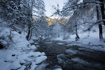 water flowing from the stream in snowy weather