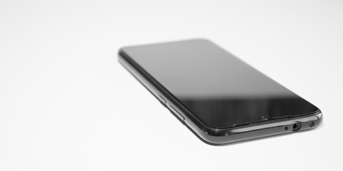 Black phone. On white background. Close-up