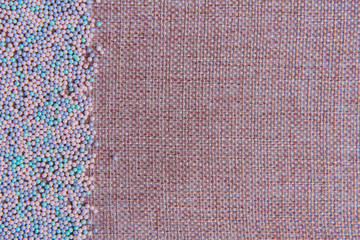 Background of linen yarn, burlap. On one side, the card is decorated with pastry topping. All in...