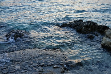 Big blue deep sea and a rock
