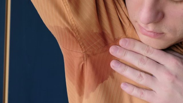 Sweating. Business man with wet armpit smelling bad