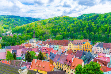 Top aerial panoramic view of Loket town colorful multicolored traditional typical buildings, green forest hills background, Karlovy Vary Region, West Bohemia