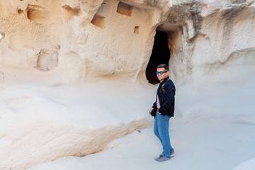 a man stands at the cave. Cappadocia Turkey.