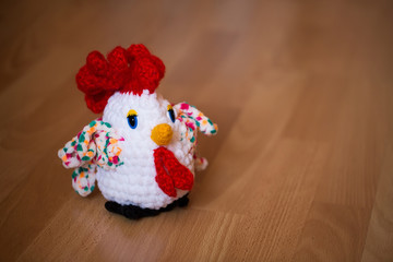 Symbol of the year 2017, the year of the rooster. Knitted cock, isolate. Textile decoration for interior design or Christmas tree. Perfect for a gift.
