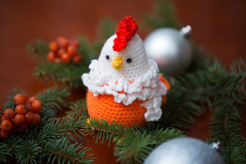 New Year 2017 symbol - handmade rooster with fir branches and cranberry