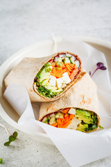 Vegan tortilla wraps with tofu, cucumber, carrots and avocado. - obrazy, fototapety, plakaty