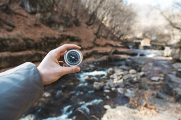 man hand compass in river