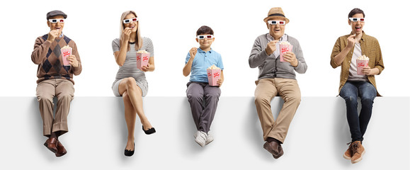 Young and elderly people sitting on a panel eating popcorn and watching a 3d movie