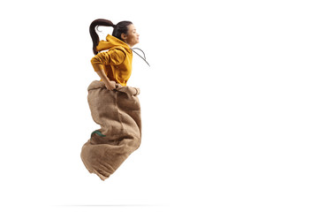 Young female jumping inside a sack