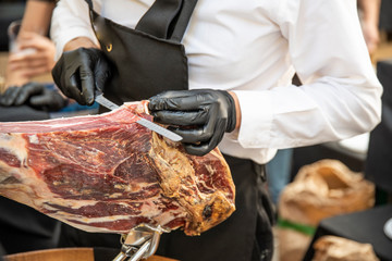 Spanish appetizer ham Authentic piece of Iberian ham cut by artisan hands with a special knife in very thin slices so that they preserve all the natural flavor of the product