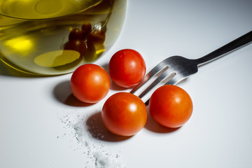 cherry tomatoes with oil, salt and fork