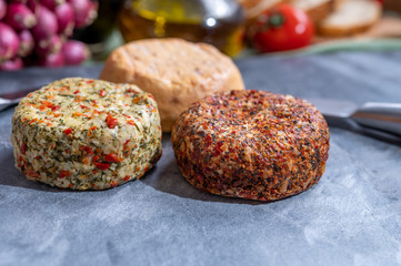 Different french soft goat cheeses made with spices and herbs