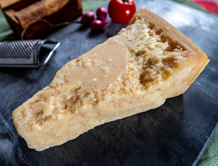 One piece of authentic Parmigiano-Reggiano or Parmesan Italian hard, granular cheese