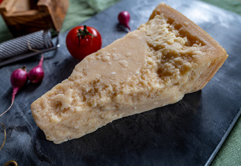 One piece of authentic Parmigiano-Reggiano or Parmesan Italian hard, granular cheese