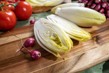 Fresh Belgian endive or chicory bitter salad ready to cook or eat