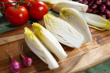 Fresh Belgian endive or chicory bitter salad ready to cook or eat