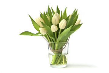 White tulips bouquet in glass vase isolated on white background. Spring bouquet of fresh tulip flowers..