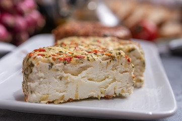 Different french soft goat cheeses made with spices and herbs