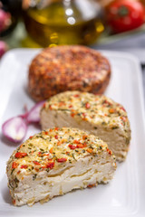 Different french soft goat cheeses made with spices and herbs