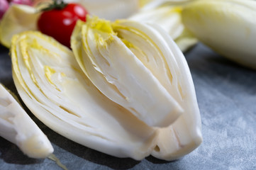 Fresh Belgian endive or chicory bitter salad ready to cook or eat