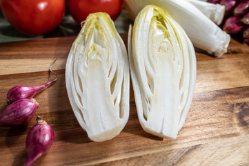 Fresh Belgian endive or chicory bitter salad ready to cook or eat