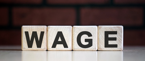Wage on wooden blocks. Wages rate. Business concept.