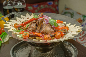 Lamb ribs and baked vegetables are on the steam table