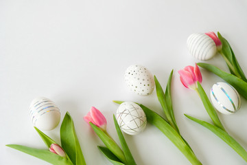 Fototapeta na wymiar White easter eggs with silver pattern and pink flowers