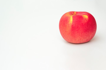 Red apple on white background, close up with copy space