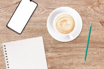 Phone and coffee on a vintage wooden background. Technology concept background. White screen phone copy space. Concept photos of desks / commercial backgrounds.