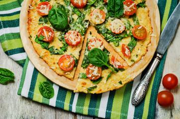 Cauliflower pizza crust with tomato and spinach