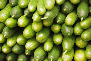 Close-up full frame view of a stack of fresh organic cucumbers displayed at a market stand	