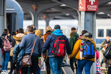 Travelers and commuters waiting for a train on the train platform of Bucharest North Railway...