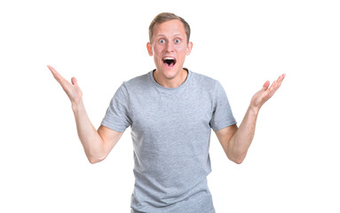 Naklejka premium Wow! Astonished young man spread his arms in different directions, delightedly isolated on a white background.