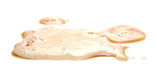Spilled beer puddle with foam isolated on white background and texture, side view