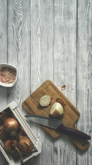 Flat lay of fresh cutted onion on wood chopping board