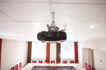 Projector on the ceiling. Interior of empty modern meetingroom. Conference room in a hotel for...