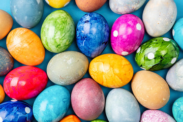 Different easter eggs on blue table