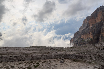 Material ropeway to alpine hut Rifugio Alimonta and mountain alps panorama with clouds in Brenta...