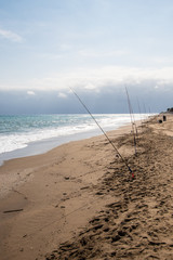 Fishing rods on sea beach. Fishing tourism and vacation concept