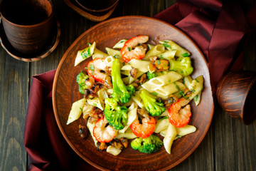 Sea fruit penne pasta with vegetables, top view image