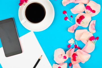 Flat lay composition with beautiful flowers and clean page, cup of coffee. Content plan concept.