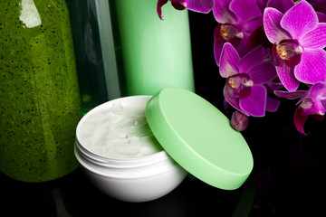 bottles with cream on black background