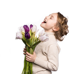 Little girl with a bouquet of tulips.