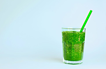 Green detox smoothie with vegetables on blue background. Healthy drink.