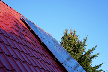 photovoltaic panels on the roof with shadow of a single-family house in the countryside - 329182208