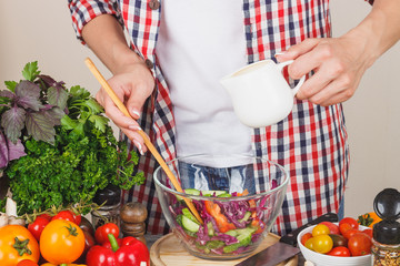 Woman cooks at the kitchen, body part
