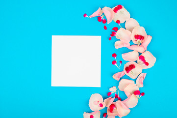 Blank frame mockup with pink petals. Beautiful floral pattern. Flat lay style